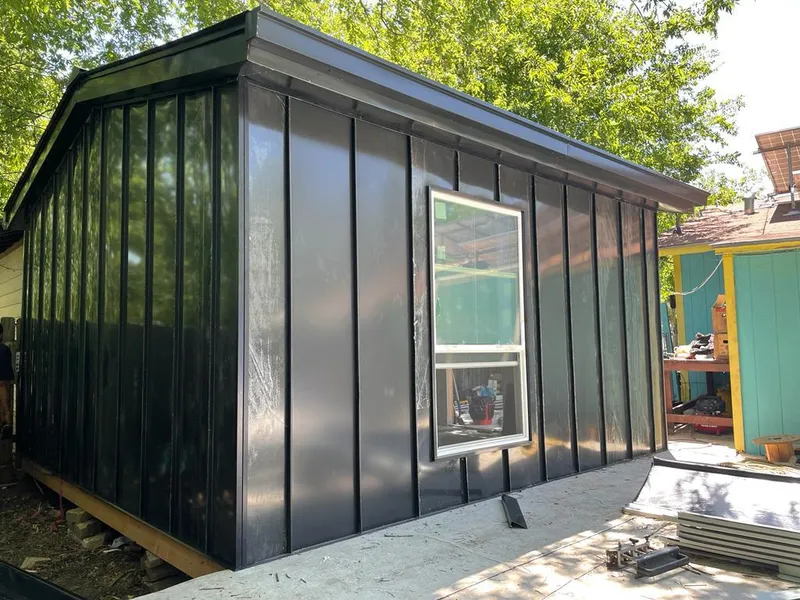 Black standing seam metal wall panels for Metal Roof Installation in College